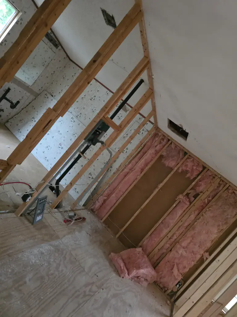 Interior framed opening with insulation and unfinished wall surfaces