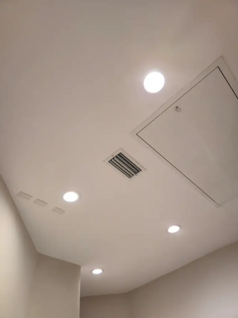 Alternate view of a white ceiling, recessed lighting, and an access panel